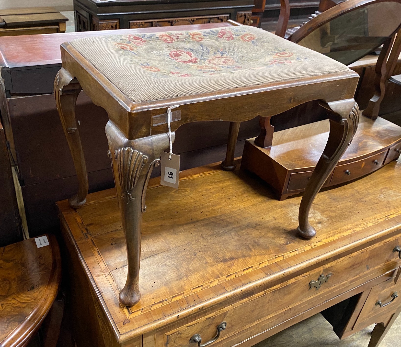 A Queen Anne Revival walnut dressing stool, width 57cm, height 46cm together with a Regency mahogany bow front toilet mirror